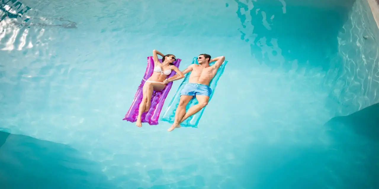 Couple In Pool; Courtesy of wavebreakmedia/Shutterstock.com