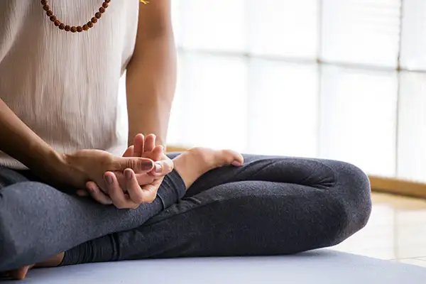 A woman meditating.