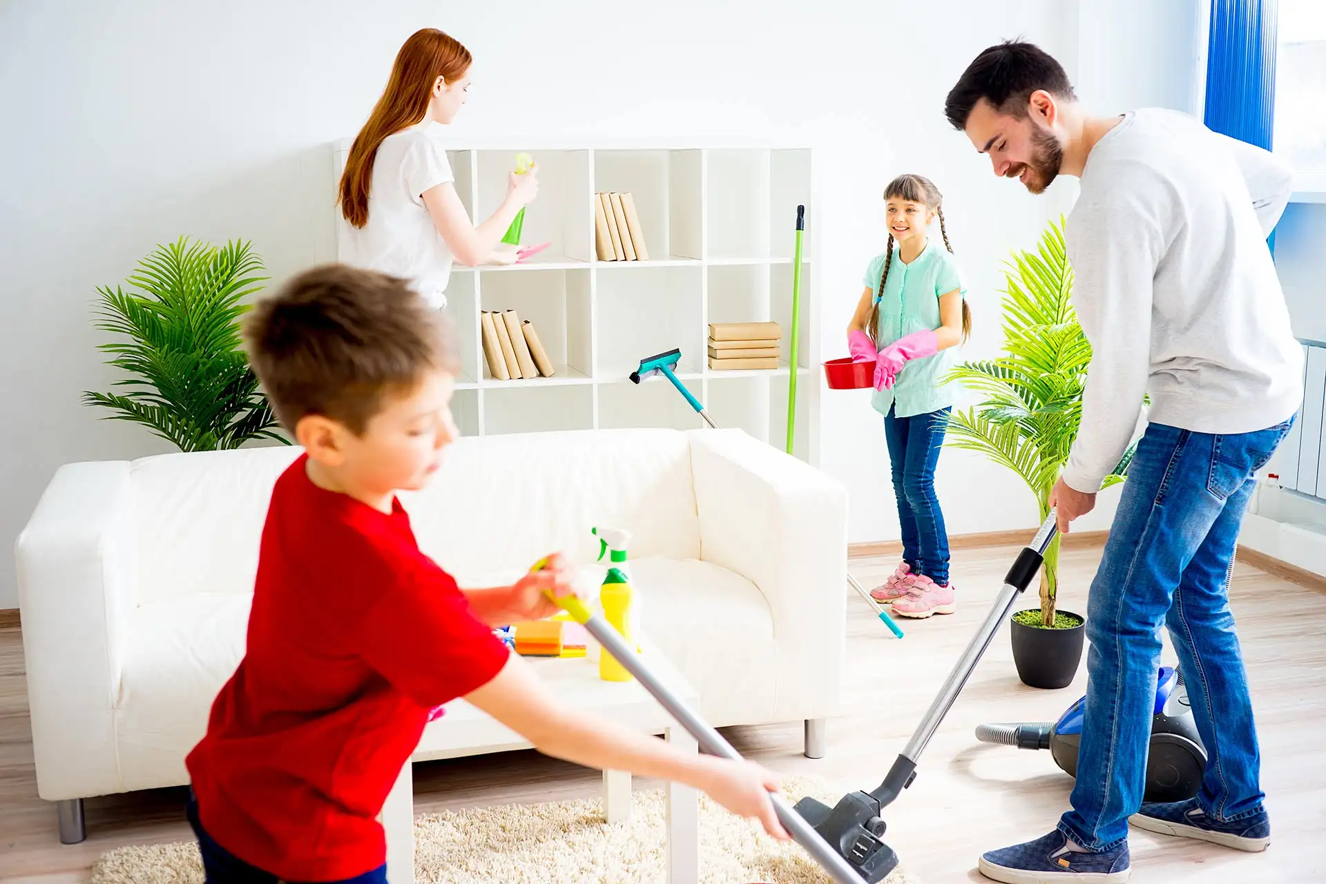 A family cleaning the house before going away on vacation.
