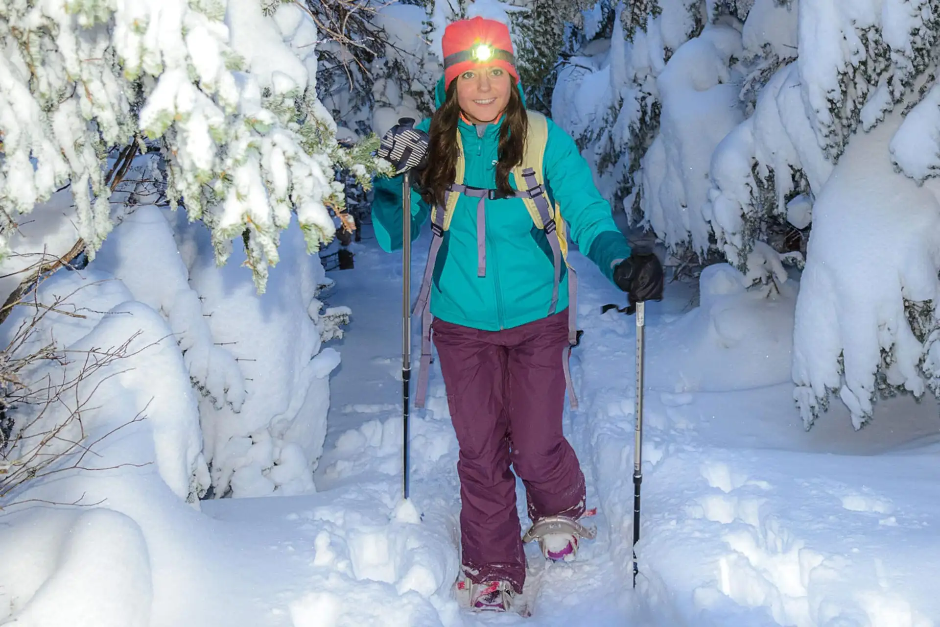 A young woman on a snowshoeing hike at Stratton in Vermont.