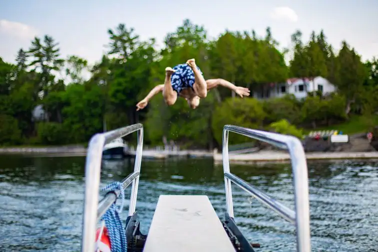 Boy Jumping in Lake at Basin Harbor Resort in Vergennes, Vermont