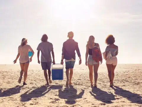 Teens With Beach Cooler; Courtesy of Jacob Lund/Shutterstock.com