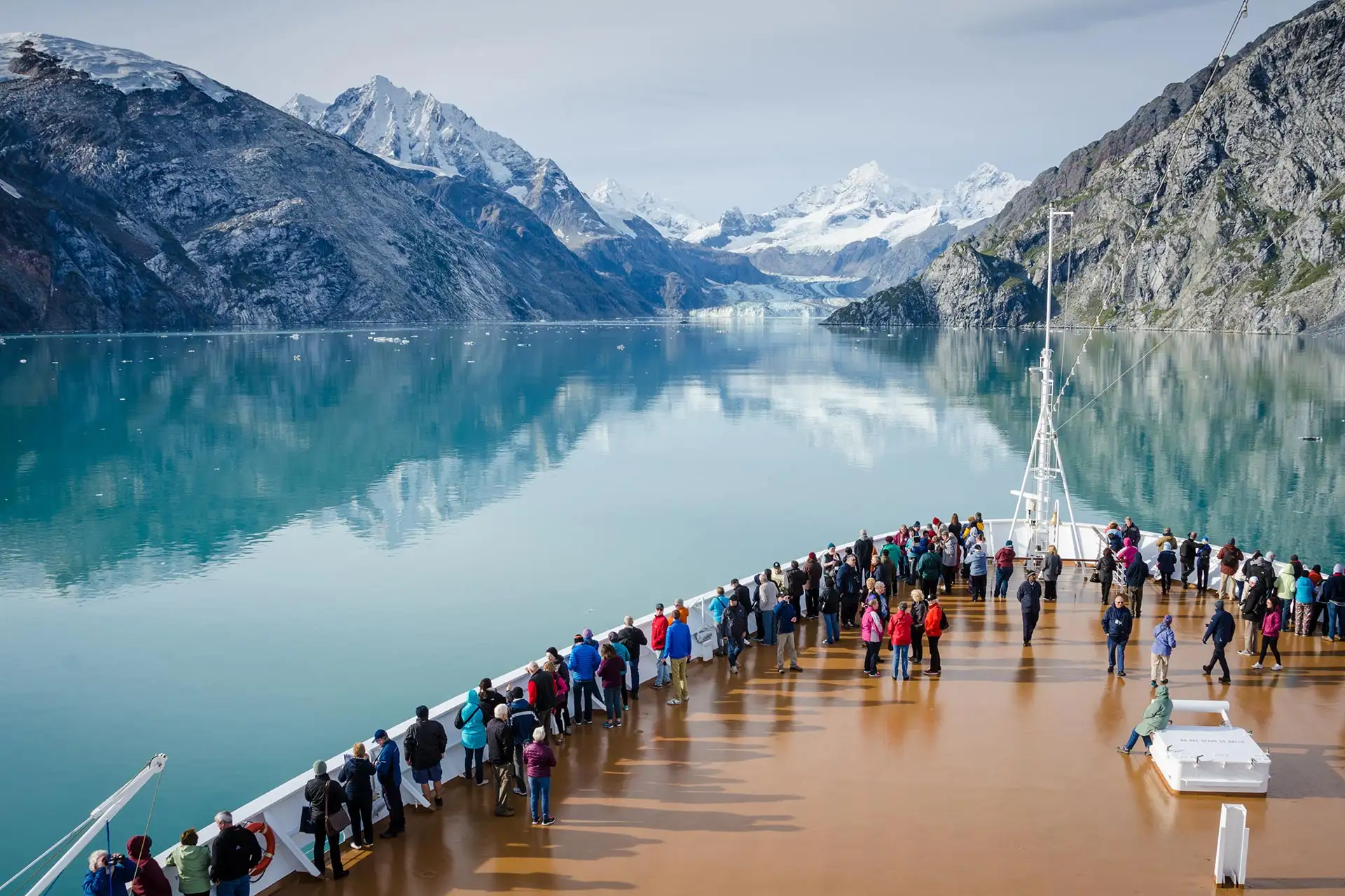 A group of people onboard a cruise ship enjoying the magnificent views of Glacier Bay in Alaska.