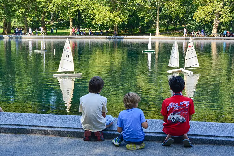 Kids Sailing Miniature Boats on the Water Conservatory in Central Park in New York City; Courtesy of Christopher Penler/Shutterstock.com