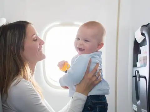 Mom with Baby on Flight; Courtesy of Shutterstock/Tomsickova Tatyana