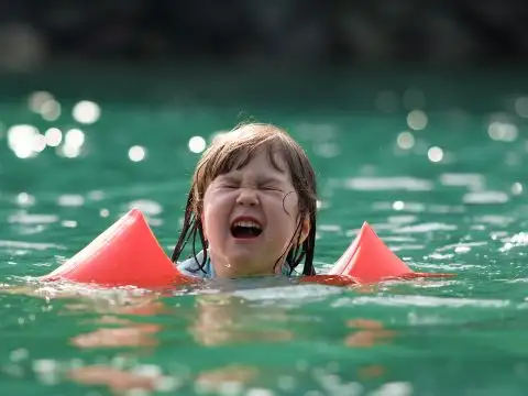 Crying Girl in Pool; Benoist/Shutterstock.com