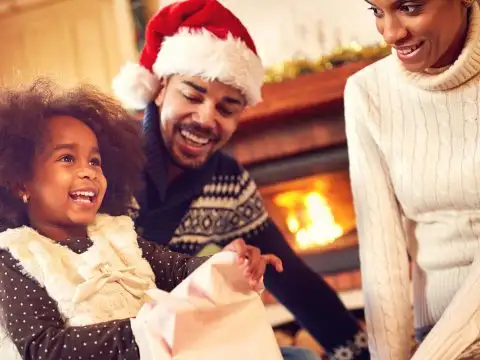 Family Opening Holiday Gifts; Courtesy of Lucky Business/Shutterstock.com