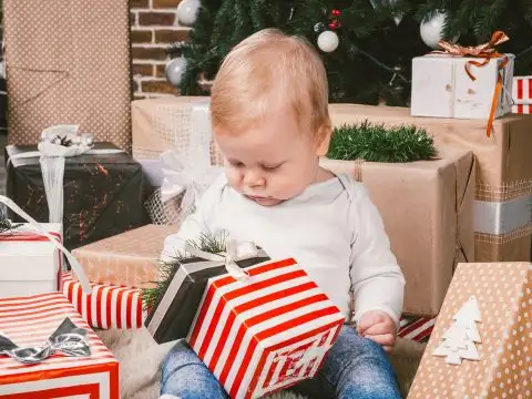 Infant Opening Holiday Gifts; Courtesy of fotoliza/Shutterstock.com