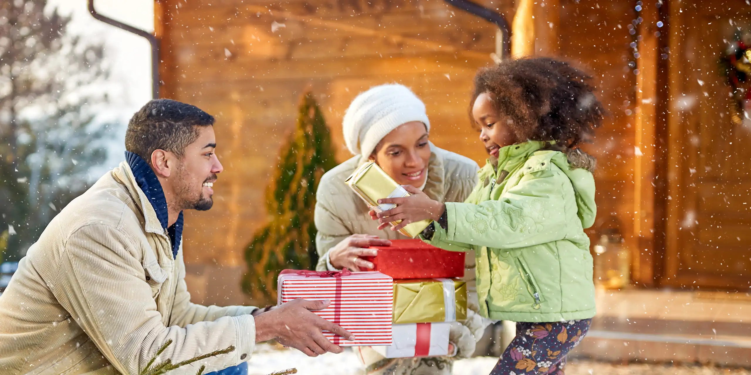 family gift giving holidays snowing; Courtesy of Lucky Business /Shutterstock
