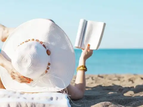 Woman Reading on the Beach; Courtesy of Ahmet Misirligul/Shutterstock.com