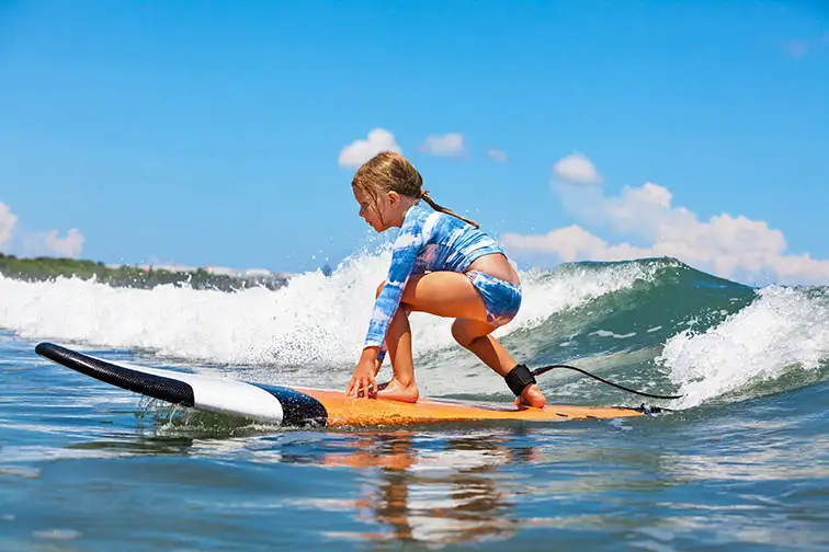 Young Girl Surfs in Maui