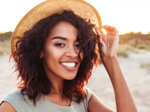 Woman smiling wearing a sun hat