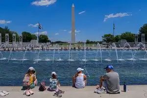 family sits on the national mall in washington, d.c.; Courtesy of Matt Smith Photographer/Shutterstock