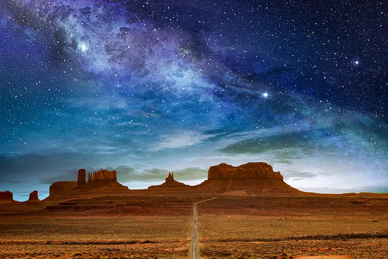 scenic route to the monument valley under a night starry sky arizona; Courtesy of paulista/Shutterstock
