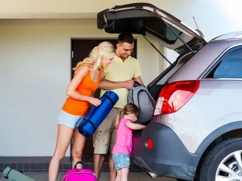 family packing car road trip