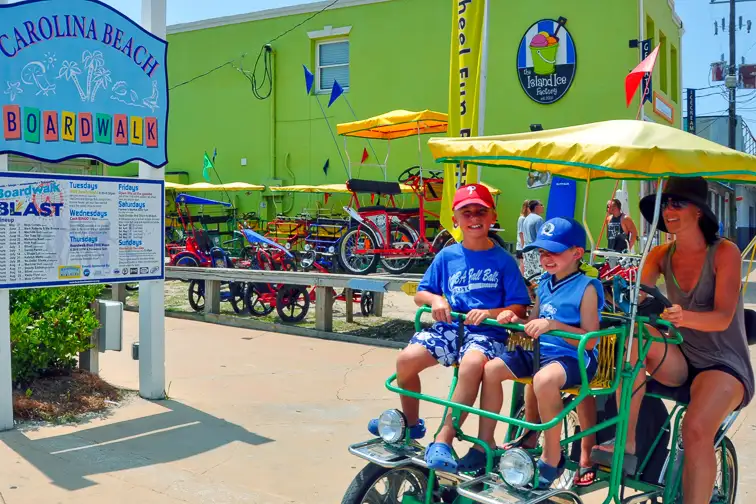 Family renting bikes at carolina beach boardwalk; Courtesy of Wilmington and Beaches CVB