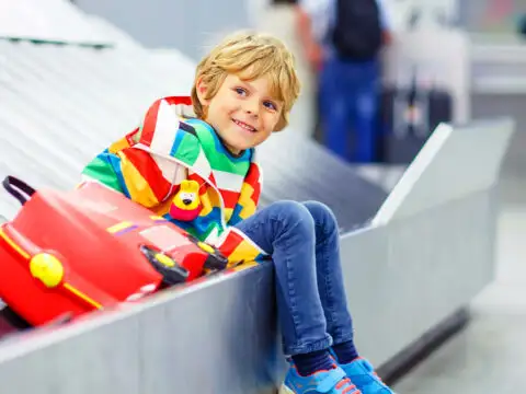 boy on baggage belt; Courtesy of Shutterstock