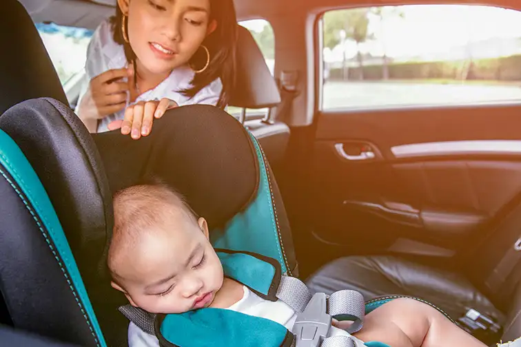 baby car seat mom peeking asleep; Courtesy of Phairin Theekawong /Shutterstock