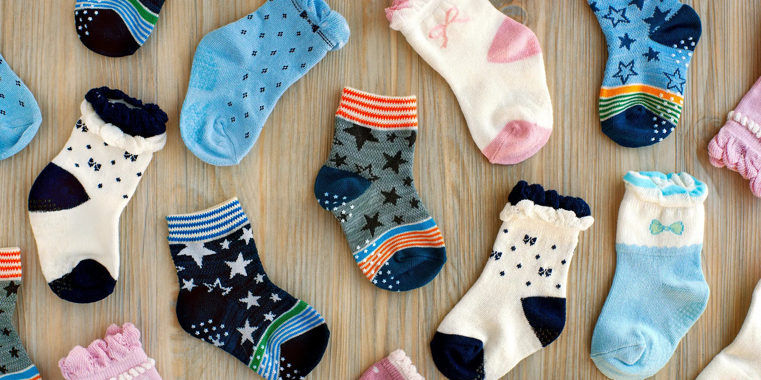 baby socks flat lay on a table top; Courtesy of Evgeniya369/Shutterstock