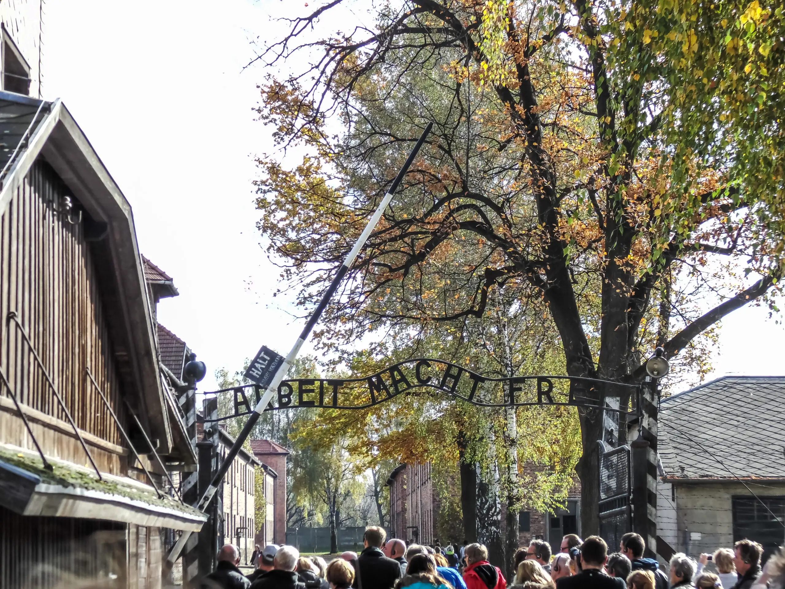  Auschwitz entrance gate with tourists; Courtesy Thomas Ortega/Shutterstock