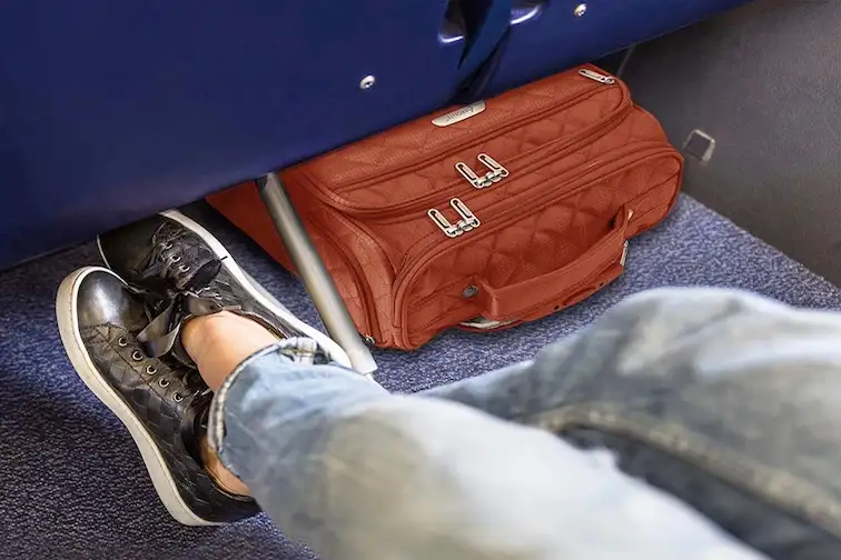 Suitcase under airplane seat