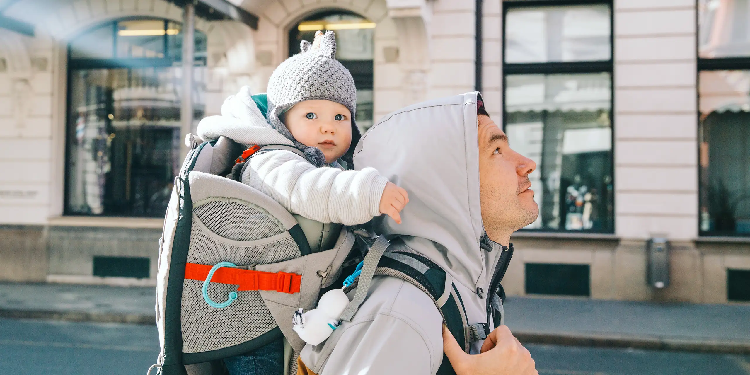 dad walking with a baby in a carrier backpack; Courtesy Natalia Deriabina/Shutterstock