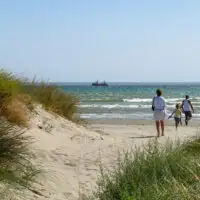 family walking to the beach. sand dunes beach michigan; Courtesy Slniecko/Shutterstock