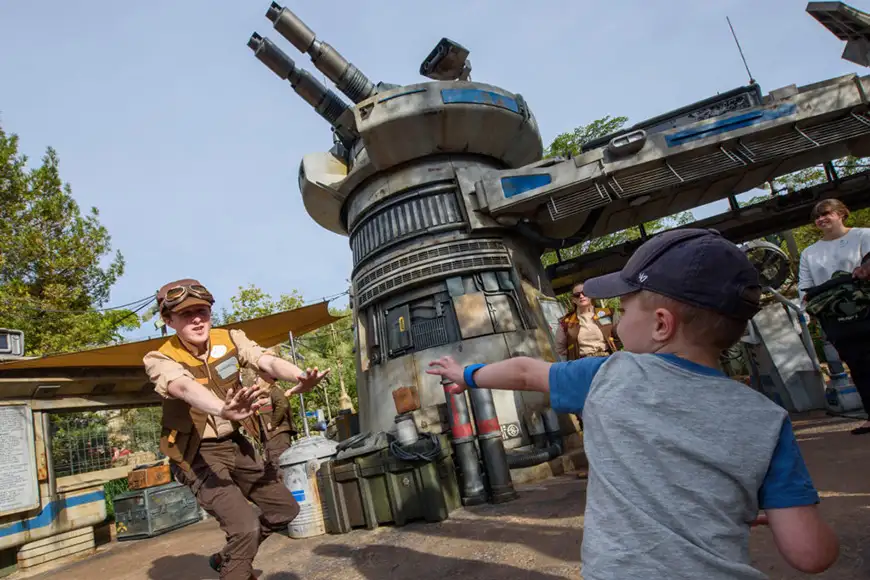 A child interacts with a Disney’s Hollywood Studios cast member at the entrance to Star Wars: ; Courtesy Disney