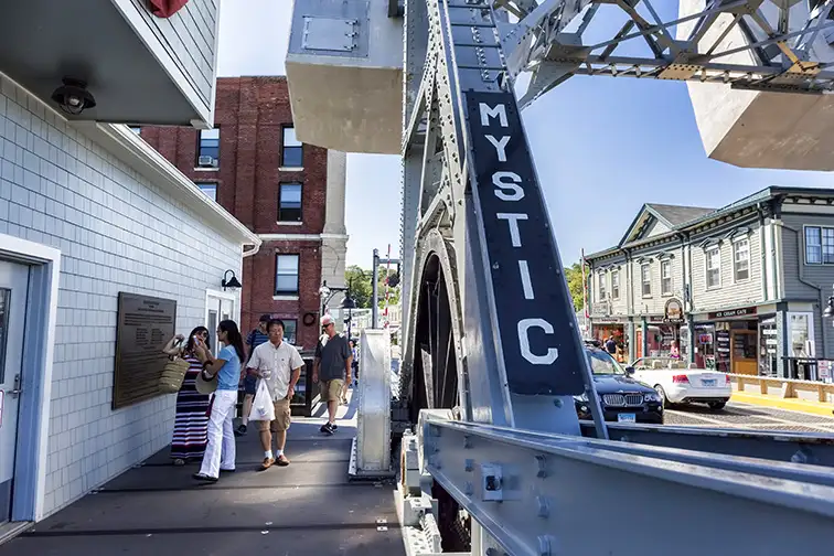 The Mystic bascule bridge spans the Mystic river, it carries foot traffic to the tourist district of town.; Courtesy Paul Latham/Shutteerstock