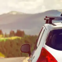 Car on a mountain road with a roof cargo carrier