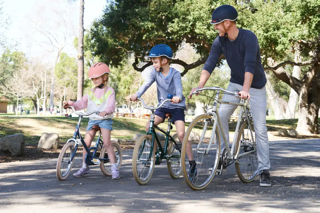 family wearing thousand bike helmets
