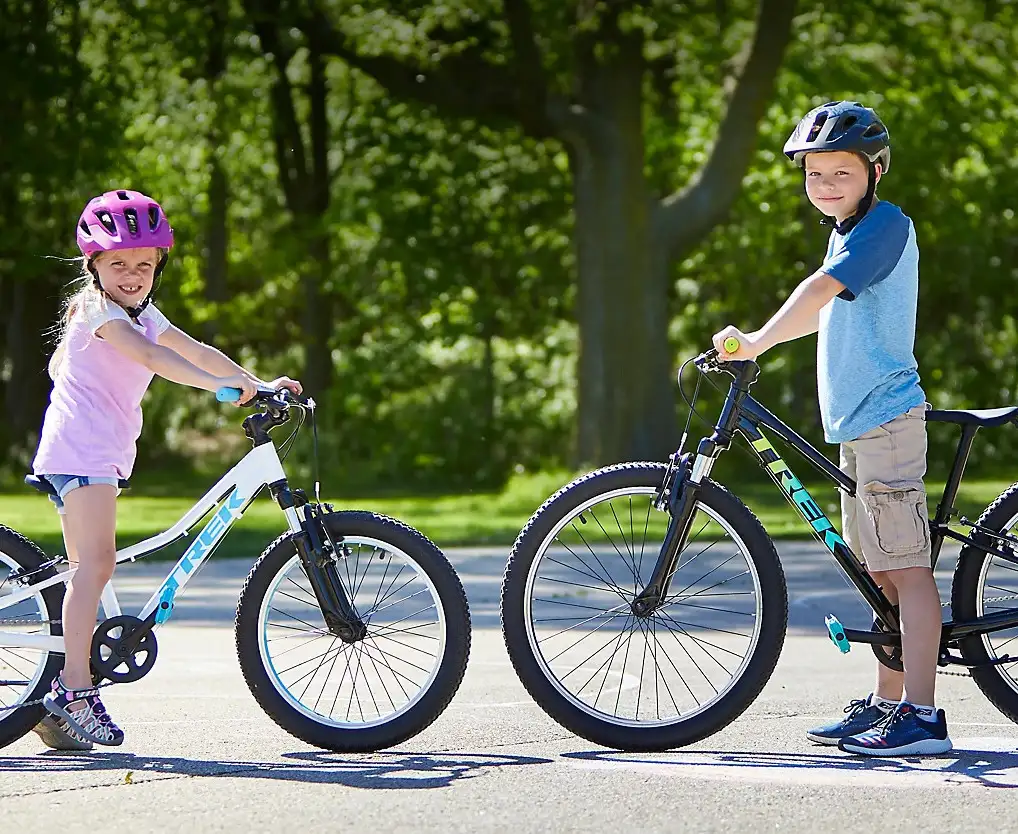 Two kids riding Trek bikes